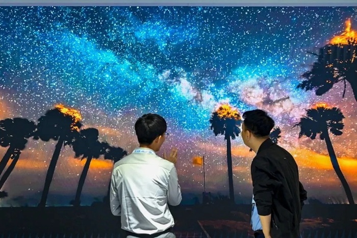 長春光博會(huì)希達(dá)電子展區(qū)，一位工作人員正在給一位觀眾講解。（長春新區(qū)供圖）